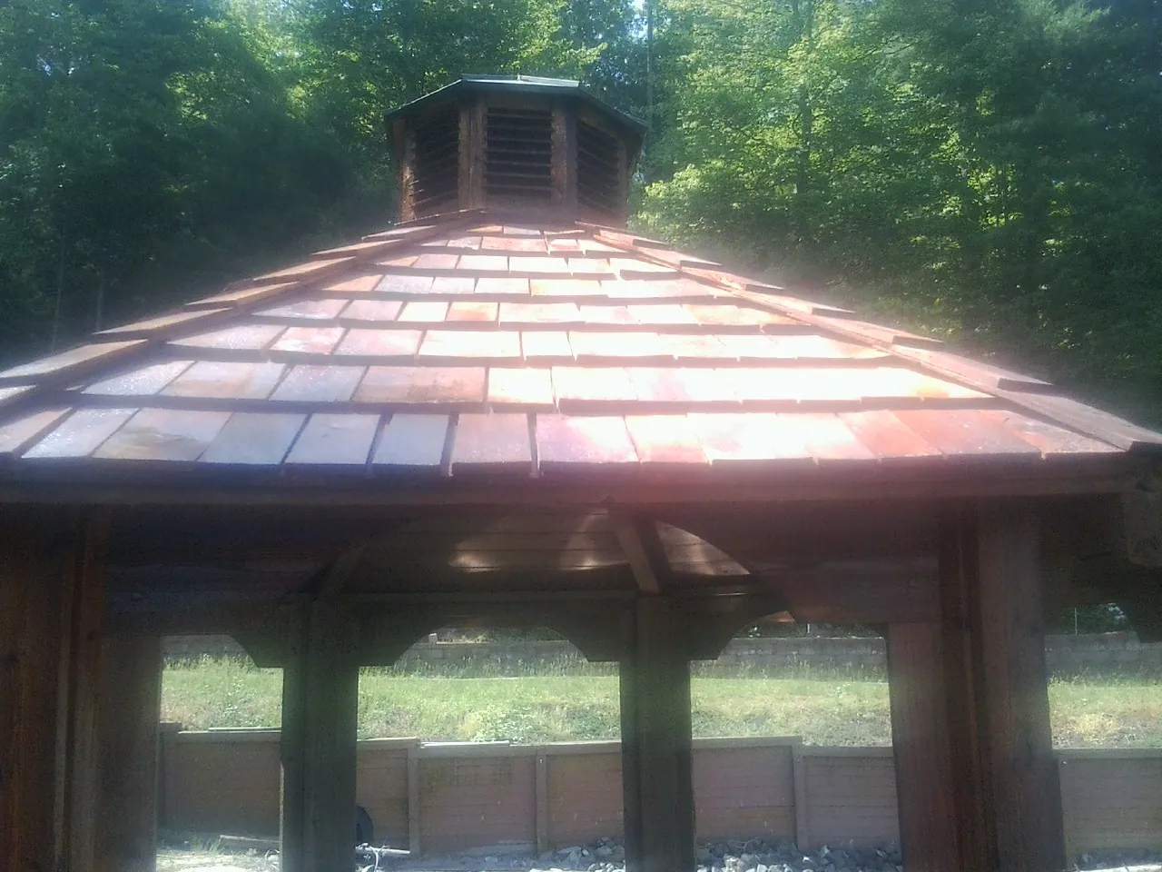 New cedar shake roof and cupola on a lakeside gazebo in Pryor